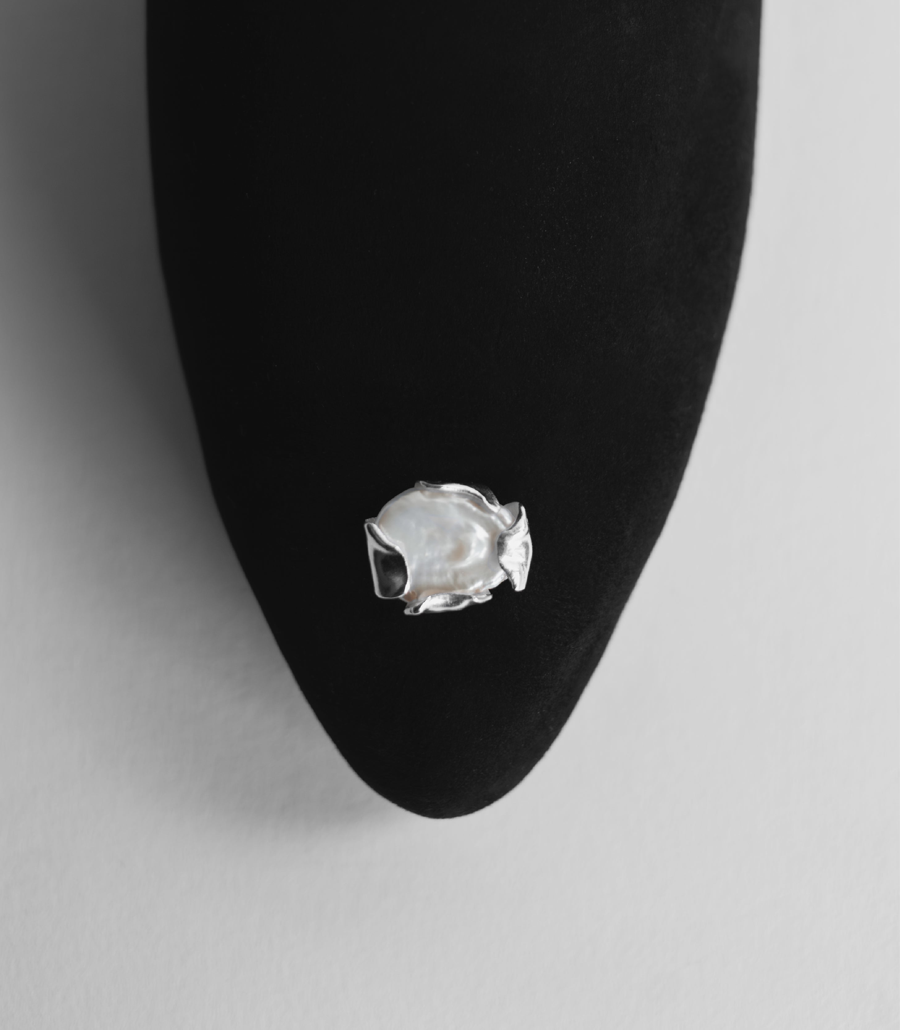 Sharp shoe silhouette with a bespoke made jewelry attached.