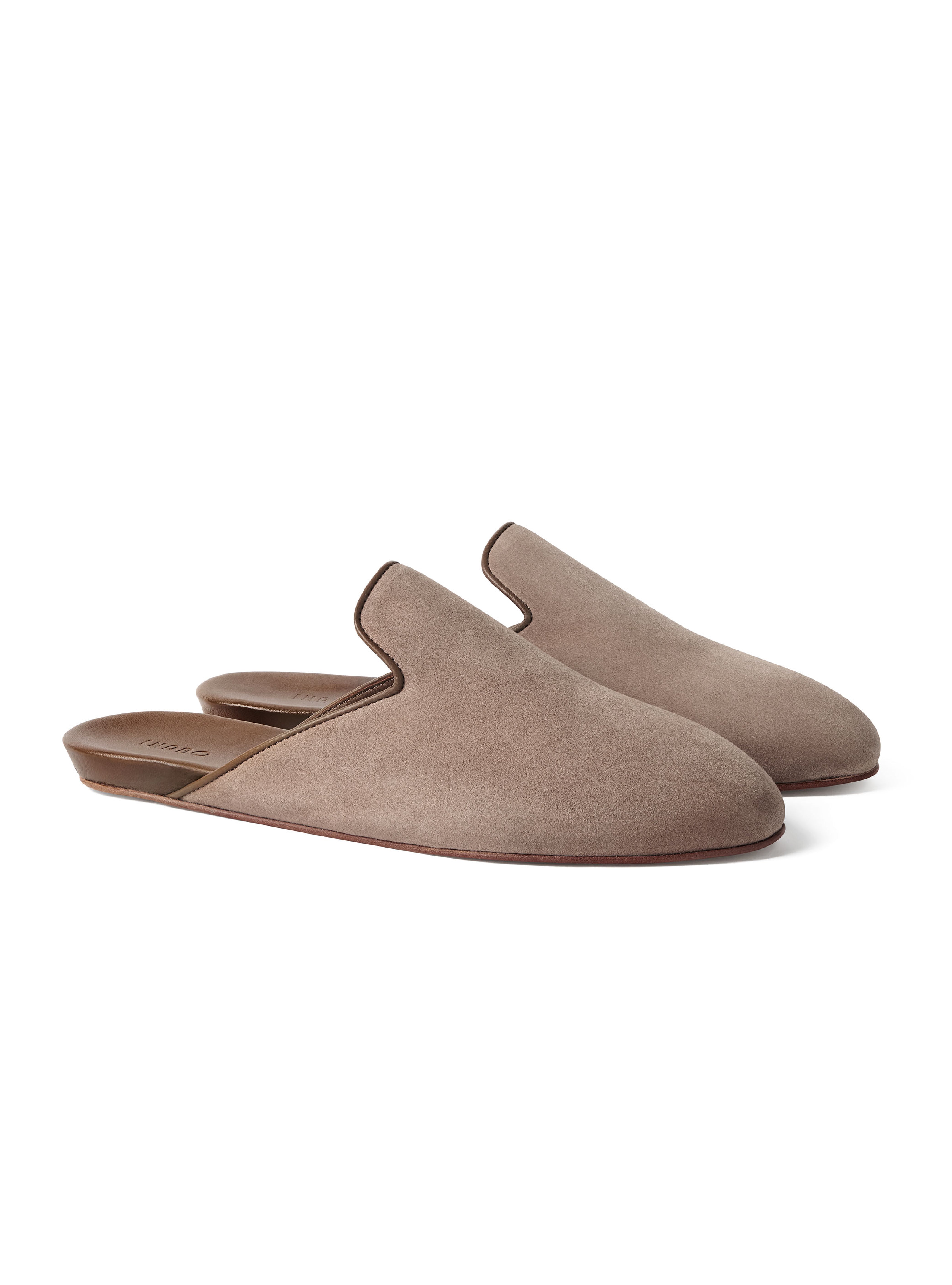 Pair of taupe suede slippers on a white background