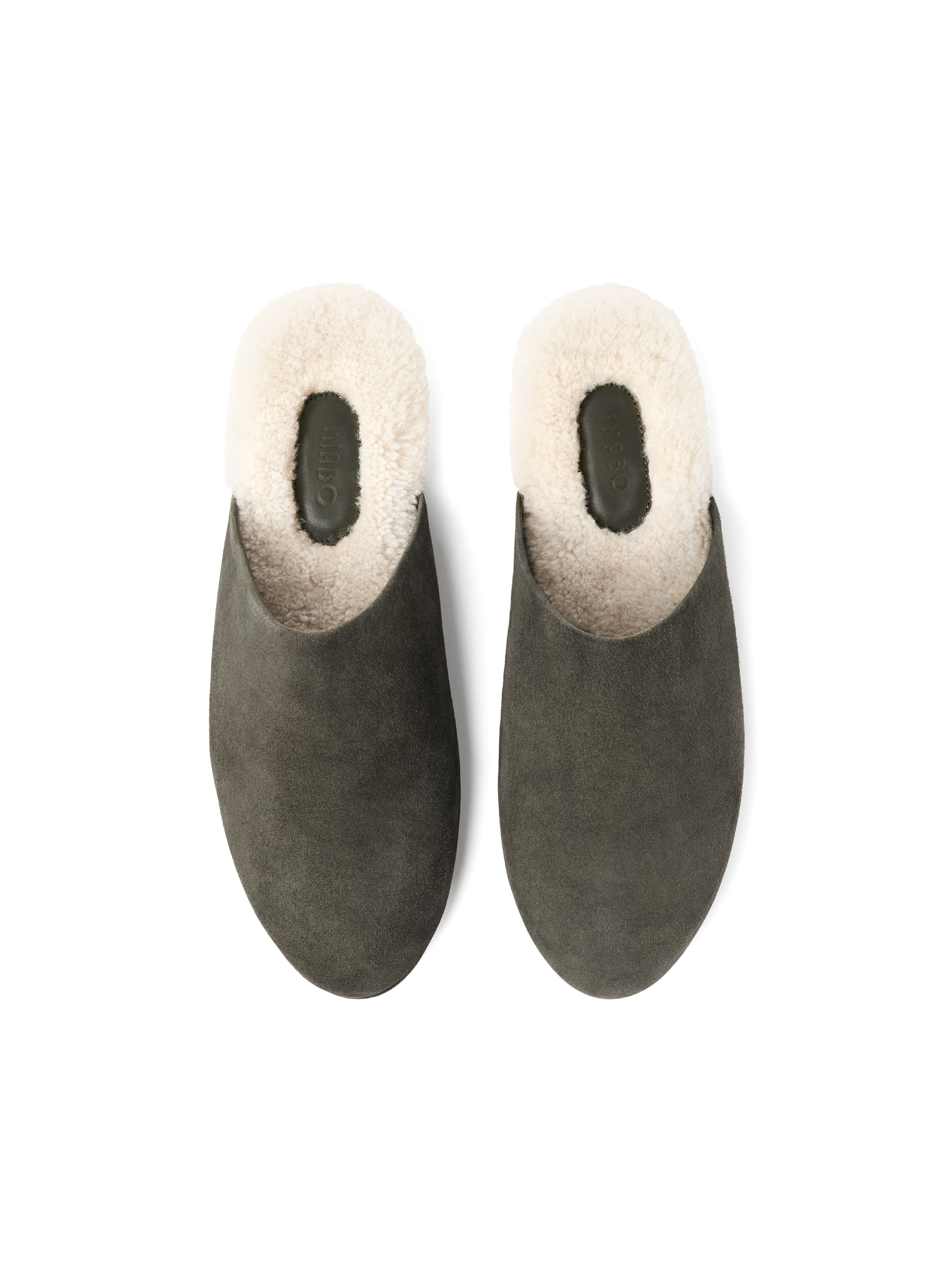 Men's pair of green suede slippers with white fur lining on a white background