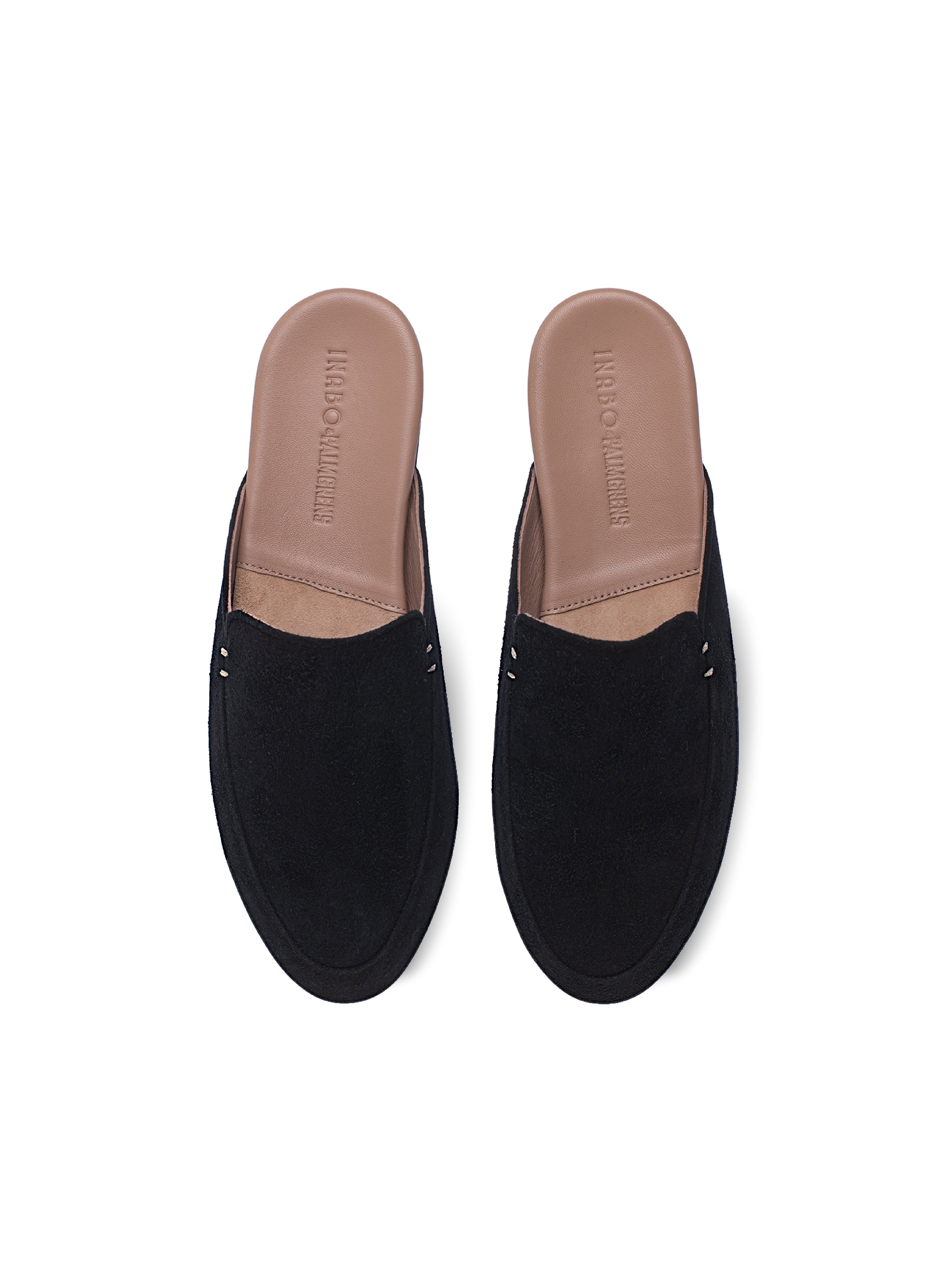 Women's pair of black suede loafers on a white background.