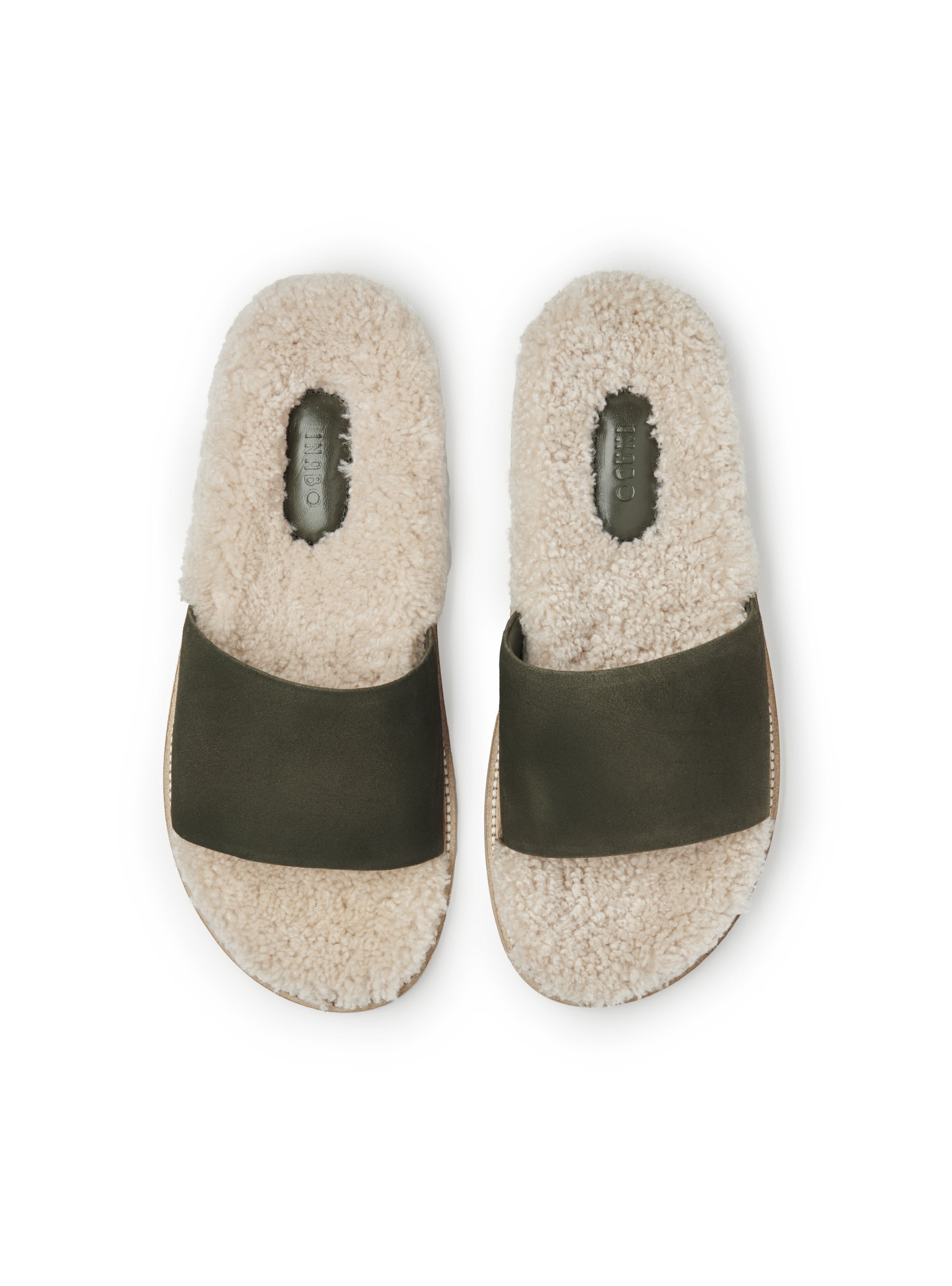 Men's pair of slip-in slippers with white fur lining, green suede, and rubber sole on a white background.