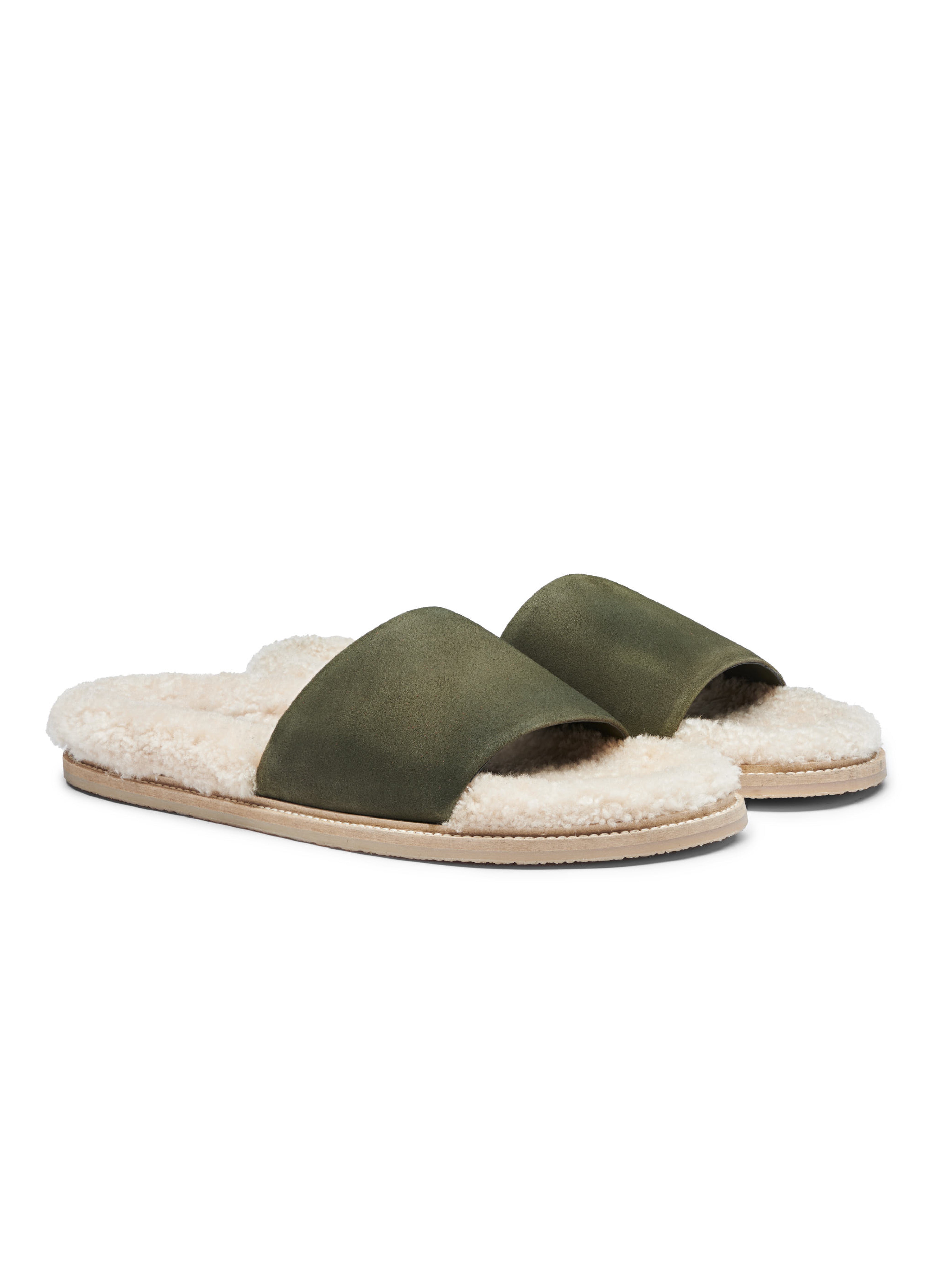 Men's pair of slip-in slippers with white fur lining, green suede, and rubber sole on a white background.