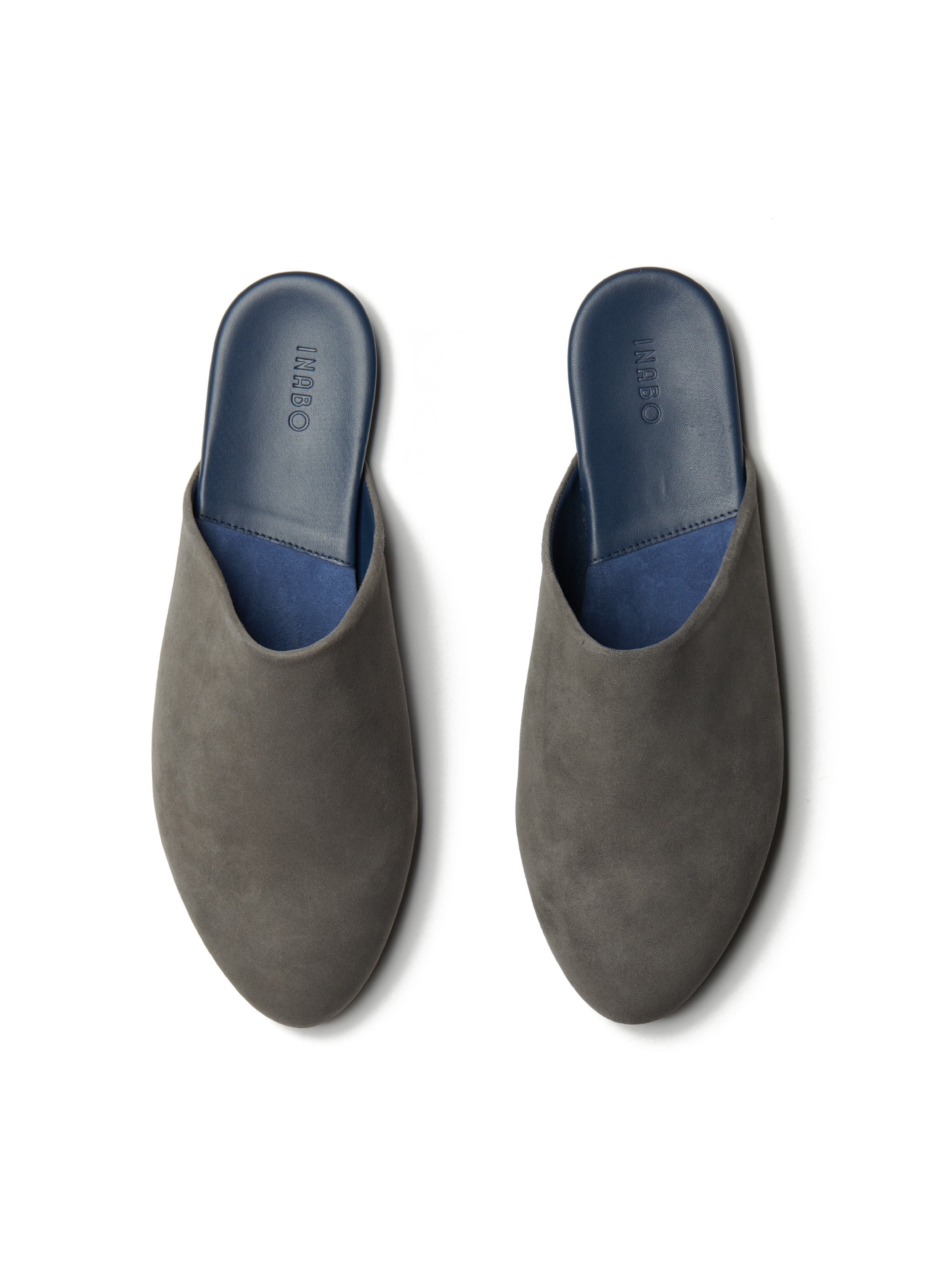 Men's pair of grey suede slippers on a white background