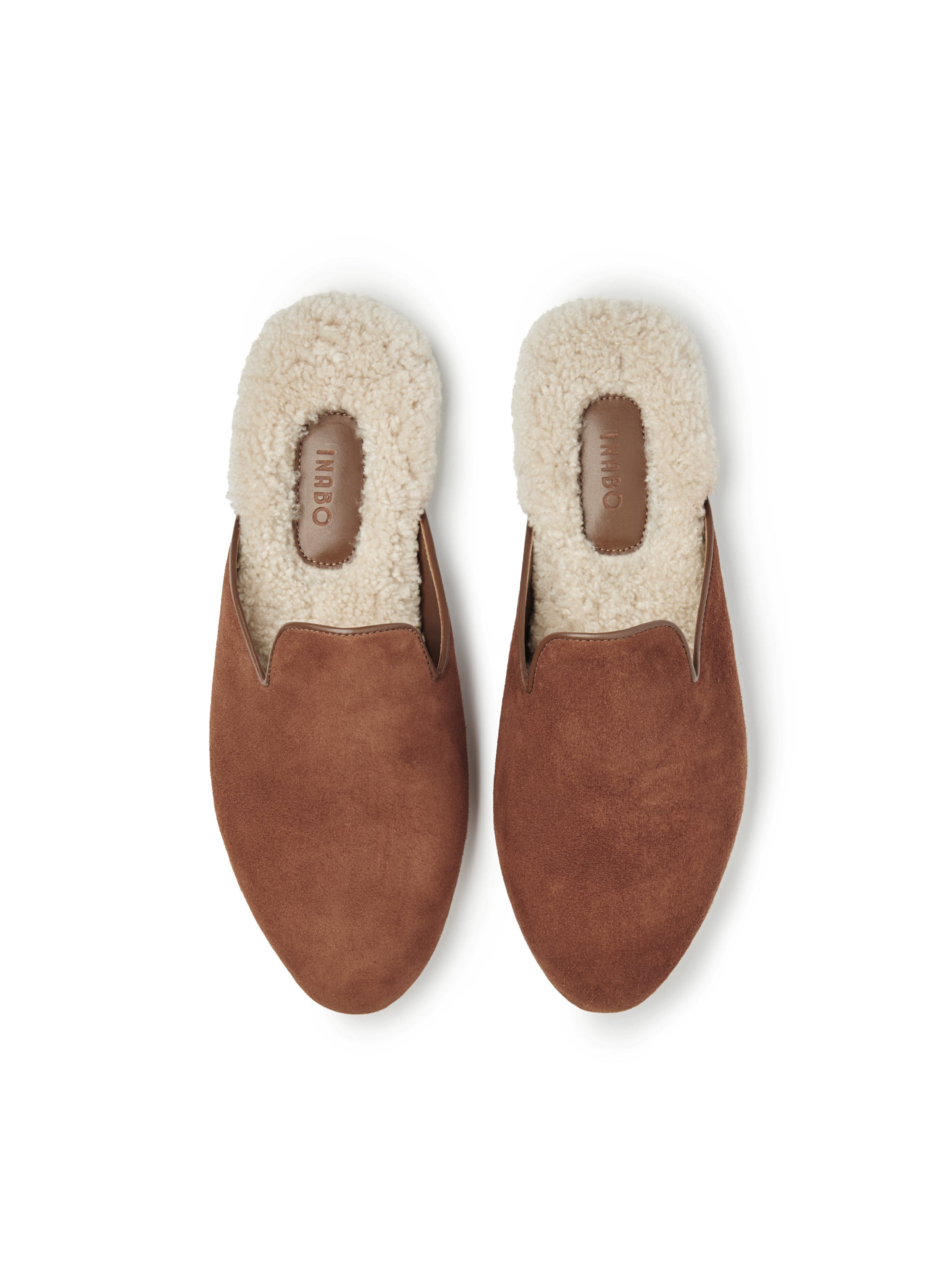 Men's pair of brown suede slippers with white fur lining on a white background