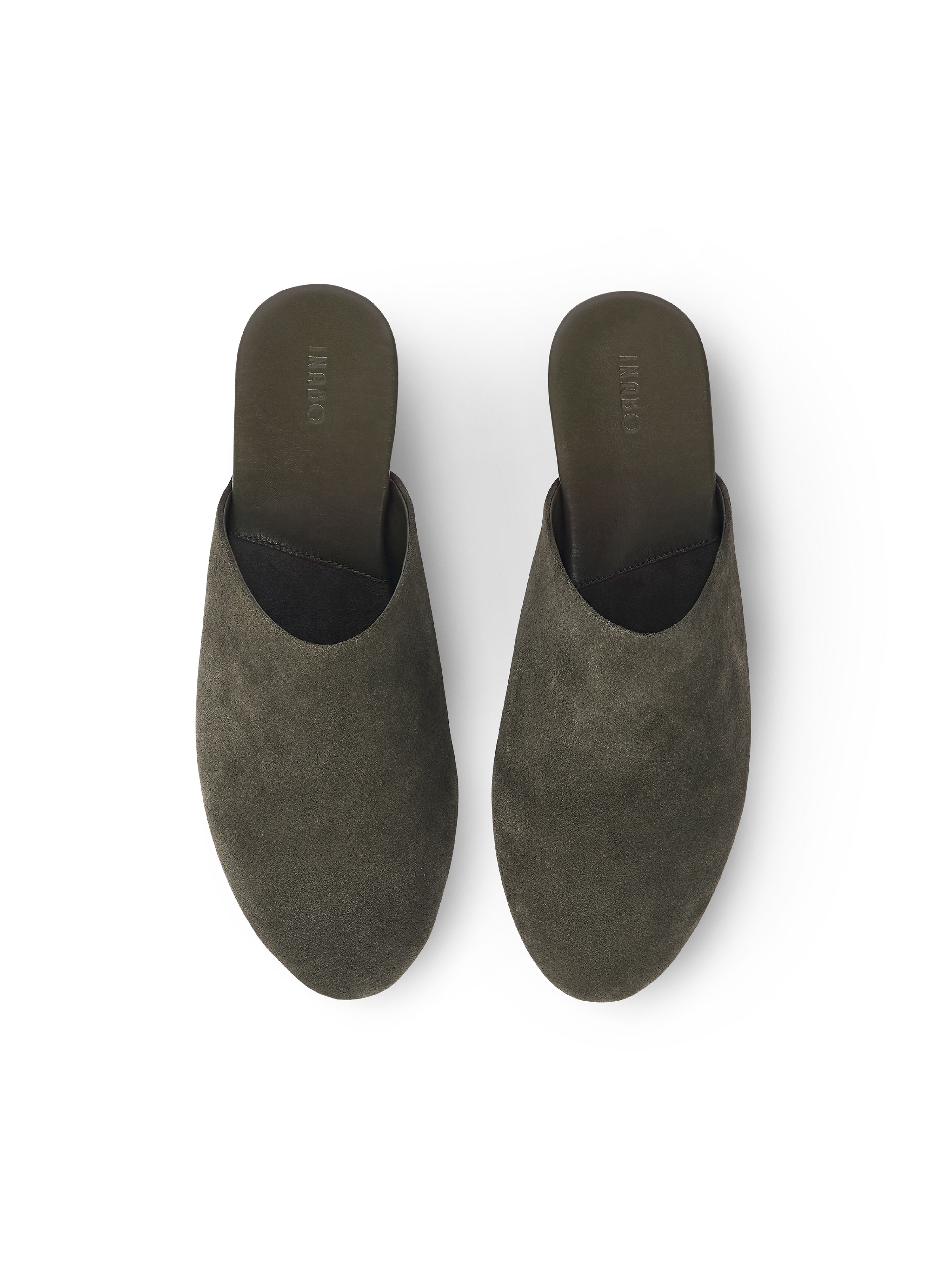 Men's pair of green suede suede slippers on a white background