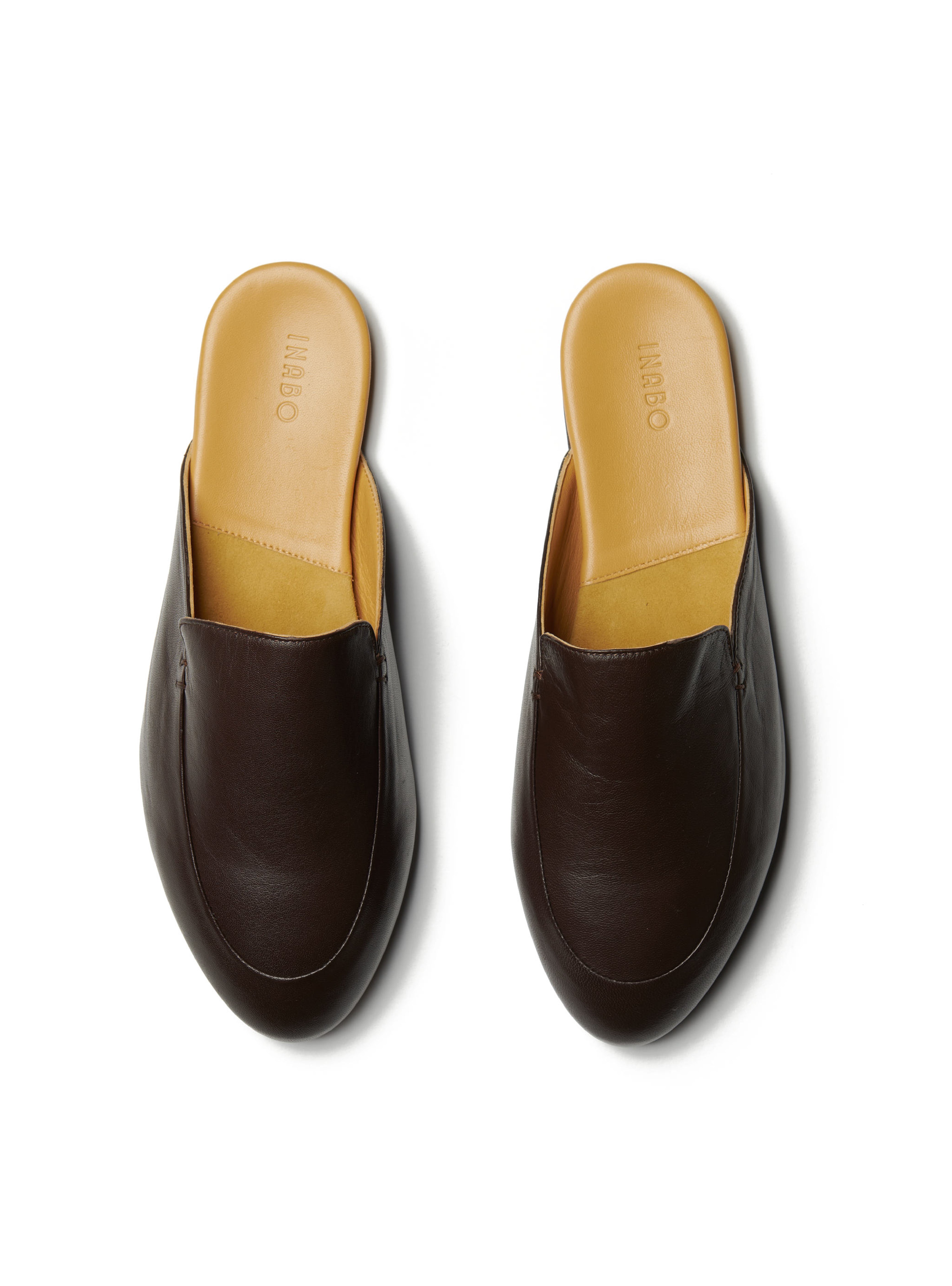 Men's pair of dark brown leather loafers on a white background